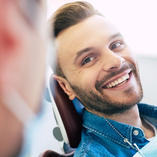 Man smiling at cosmetic dentist during consultation