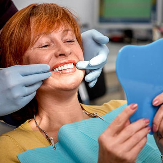 Woman in dental chair for dentures