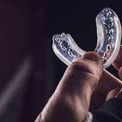 Person holding a mouthguard