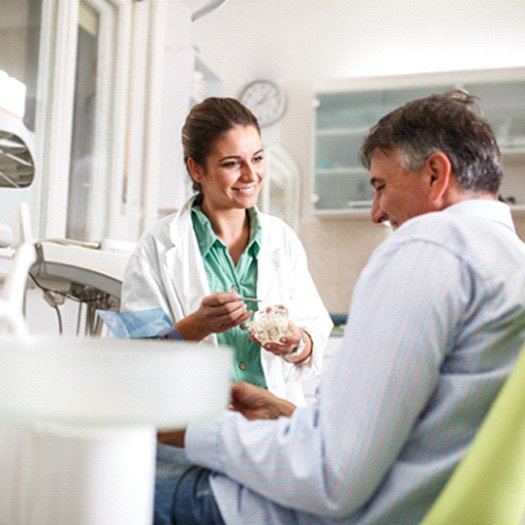 Mature patient speaking with dentist