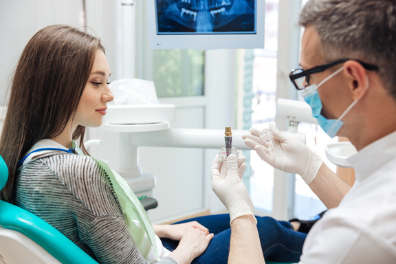 implant dentist explaining implant to patient